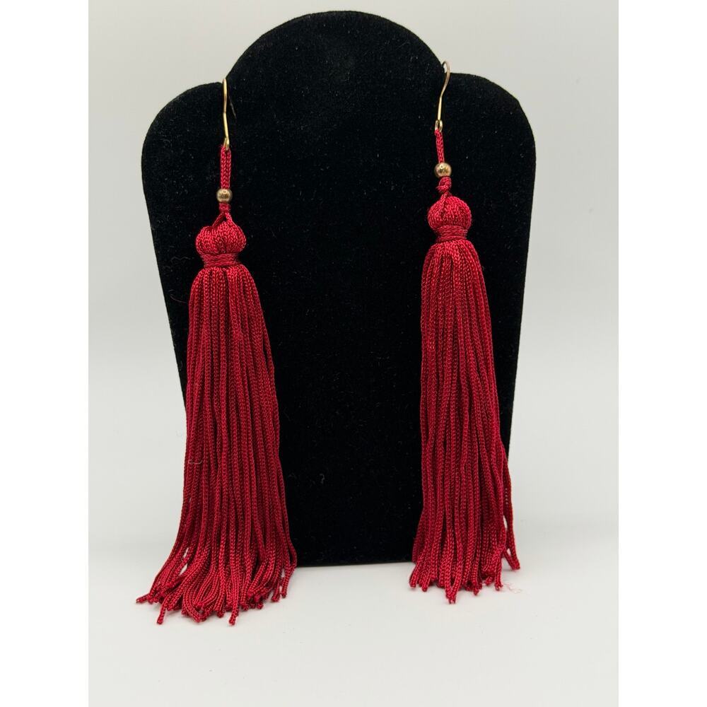 Crimson Tassel Earrings with gold‑tone accents.